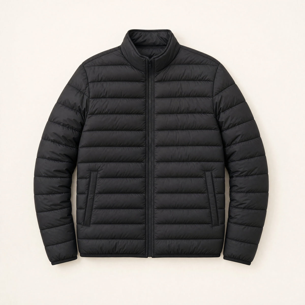 The Treeline Men's Quilted Puffer Jacket in Jet Black, front flat lay